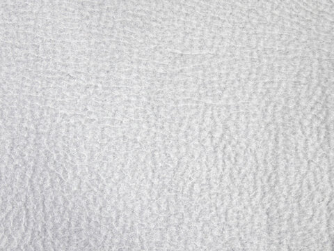 Light gray fleece fabric texture background with soft synthetic fibers