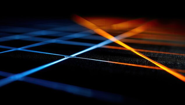Abstract crisscrossing blue and orange light beams on dark textured surface