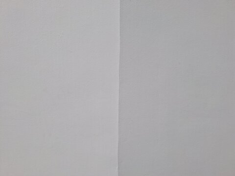 Close up of a minimalist white wall corner featuring smooth painted texture and clean geometric lines. Ideal for interior design, architectural backgrounds, and modern abstract composition themes.