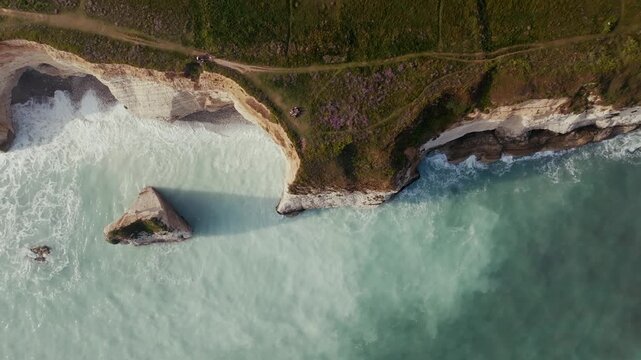 Aerial view of chalk cliffs and turquoise sea at Freshwater Bay