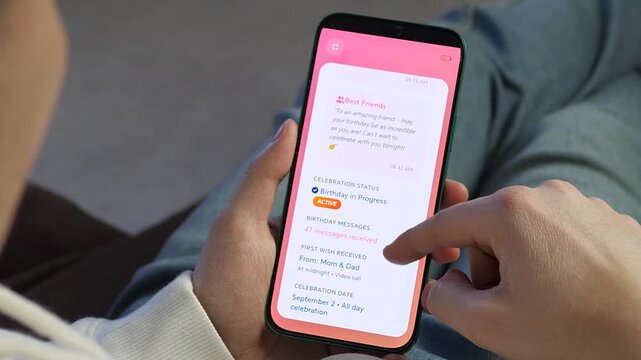 Celebrate with ease. Close-up of a person scrolling through heartfelt birthday wishes on a modern smartphone app. Perfect for videos about social connections, digital celebrations, and modern family