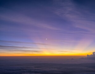 Fototapeta premium Panoramic horizon view of tranquil twilight sky, displaying gradients of deep purple and fiery orange, sun rays illuminating clouds, subtle moon