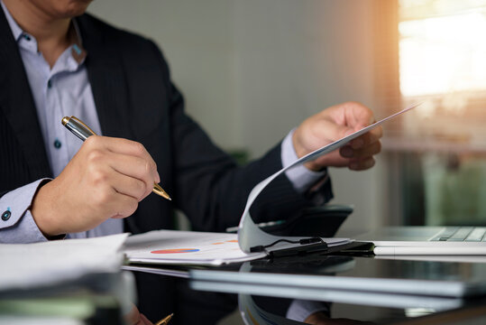 Manager hands holding document reviewing project data clipboard modern workspace. Business administration workflow management corporate governance performance review.