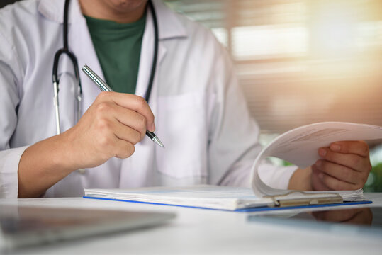 Physician holding pen signing official medical document clinic office. Healthcare bureaucracy clinical trial result doctor daily routine treatment plan.