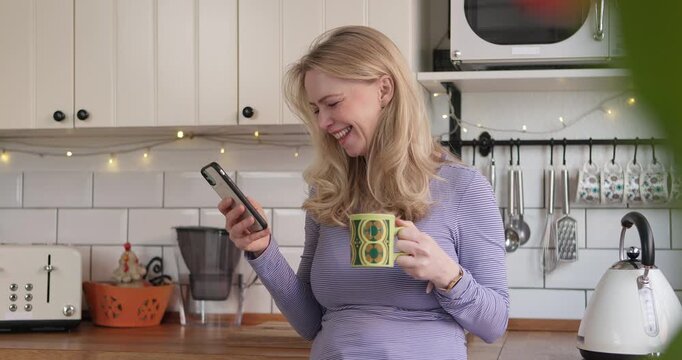 Mature woman, phone and morning coffee while laughing at funny message on social media or mobile app. Happy female model person with a tea cup and smartphone for communication, chat or connection