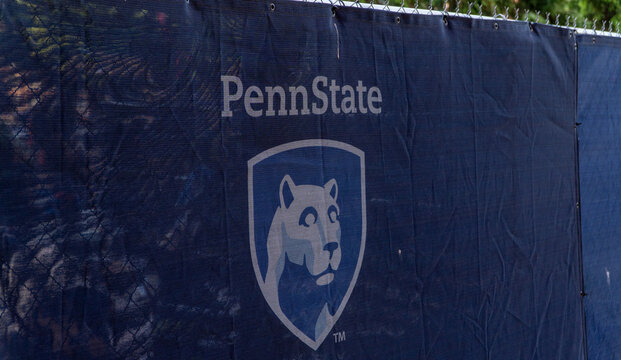 Penn State University Nittany Lion Logo on Navy Blue Mesh Fence Banner, Representing Collegiate Athletics, Education, and School Pride on Campus
