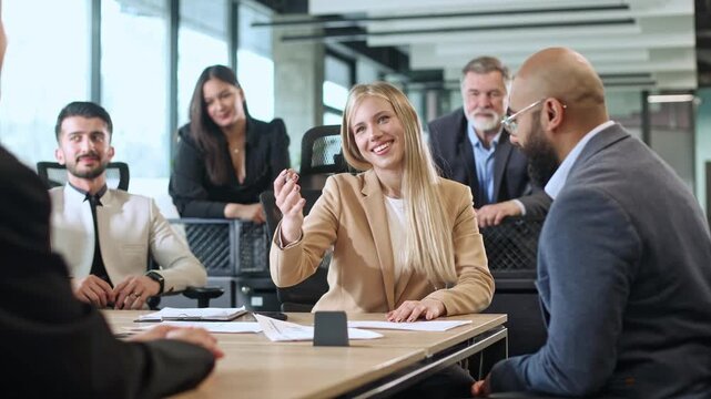 Businesswoman presents documents to colleagues during meeting