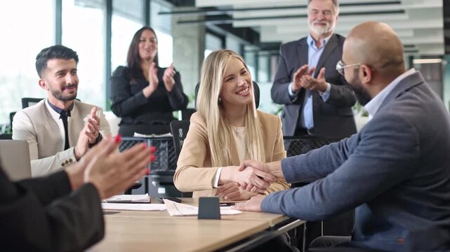 Business team gathers around table, engaged in discussion