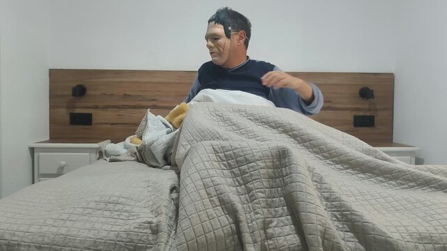 Frankenstein monster waking up slowly in bed