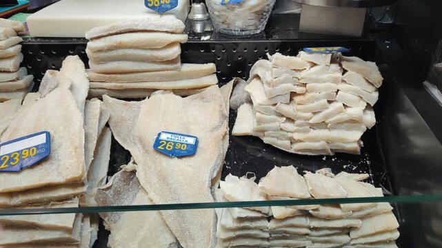 Salted cod fish bacalhau displayed at the market counter