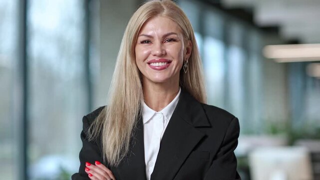 Blonde woman smiles warmly at camera