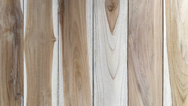 Vertical natural teak wood planks texture background. Detailed wooden board surface with beautiful grain and knots, perfect for rustic interior design and backdrop