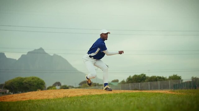 A male baseball pitcher throws a powerful pitch from the mound. His intense focus and athletic motion are clear as he delivers the ball with precision.