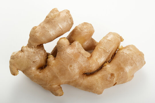 Close-up of fresh ginger root on a white background