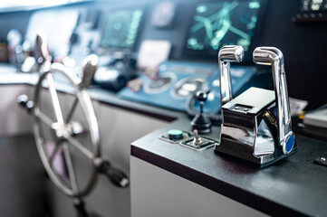 Throttle control on modern boat dashboard with navigation system and radar monitor screen in ship captain bridge or motorboat control room. Wheelhouse steering console. Nautical vessel technology © zephyr_p