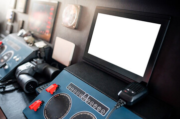 Blank monitor screen of GPS navigation and marine radar system with VHF Radio and binoculars on boat dashboard in wheelhouse or ship captain bridge. Maritime transport. Nautical vessel technology © zephyr_p