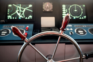 Wheelhouse steering console with digital dashboard of GPS navigation monitor, compass and marine radar system in ship captain bridge or boat control room. Nautical vessel technology © zephyr_p