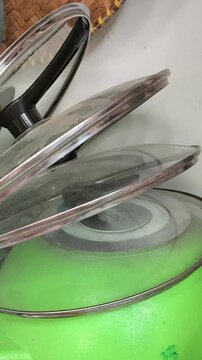 Glass Pot Lids Stacked in Modern Kitchen Storage Area
