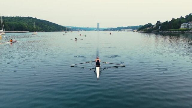 In Halifax, Nova Scotia, athletes passionately row in single, double, and quadruple boats as the sun rises. The tranquil ocean bay becomes a stage for their determination and teamwork