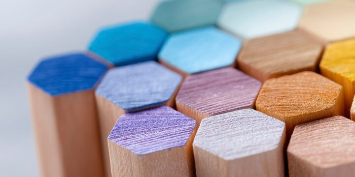 colored pencils, arranged in the shape of hexagons, showcasing their intricate patterns and vibrant colors. the background is blurred