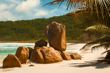 Palm-framed balancing boulder at the end of Anse Cocos Beach, La Digue, Seychelles © Maurizio De Mattei
