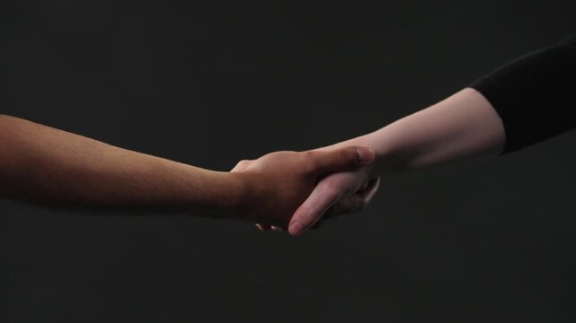Two hands with different skin tones gently touch, symbolizing connection, support, and empathy. The intimate gesture conveys a sense of care, trust, and understanding between individuals.