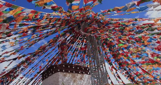 The Changqing Chunker Temple in Litang, China. Many colourful prayer flags on the mountain top beside the temple.Spirituality and meditation.