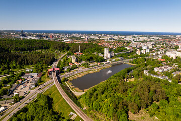 Beautiful city landscape of Gdansk in Poland, taken from the hills of Niedzwiednik district. Green forest of Tri-city Landscape Park and the Baltic Sea bay visible on the horizon. © BlackMediaHouse