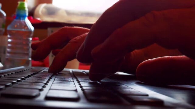 Close up macro timelapse of software engineer or programmer hands typing computer code rapidly. Modern laptop on table with shallow depth of field.Natural side window backlight.