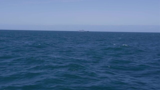 Horizontal view of fishing fleet and aquaculture farm at sea.