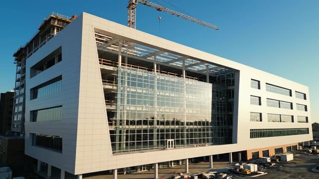Modern Hospital Wing Structure Takes Shape Under Clear Blue Sky, Showcasing Architectural Progress