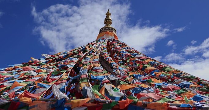 The Changqing Chunker Temple in Litang, China. Many colourful prayer flags on the mountain top beside the temple.Spirituality and meditation.