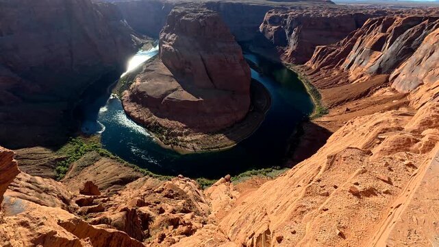 Breathtaking high angle perspective revealing the iconic horseshoe bend on the colorado river, a famous geological meander nestled within the dramatic orange sandstone cliffs of arizona