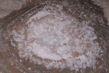 Obraz premium Crystallized sea salt deposit in a natural rock hole in Rhodes island in Greece.