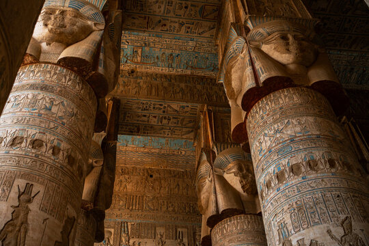 Epic ancient Egypt temple interior painted hieroglyphic ceiling stone columns pattern.
