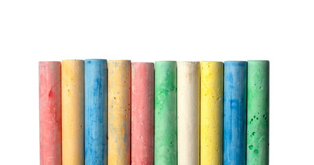 Row of colorful used chalk sticks standing upright isolated on transparent background showing worn texture pink yellow blue green white.  © Favio