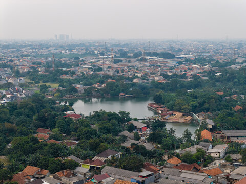 Showing dense residential kampung houses around a lake in Bekasi, Indonesia