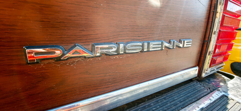 Saint Petersburg, Russia - May 23, 2026: Pontiac Parisienne emblem displayed on a vintage car with wooden paneling and chrome accents in a classic automobile setting