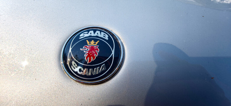 Saint Petersburg, Russia - May 23, 2026: Close-up of a Saab car emblem featuring a lion logo and the word Scania on a silver vehicle surface