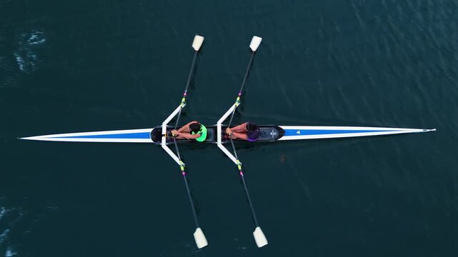 Young women passionately row in a two-seater canoe, gliding through the tranquil ocean waters of Halifax, Nova Scotia. Enjoy the beauty and teamwork of these dedicated athletes