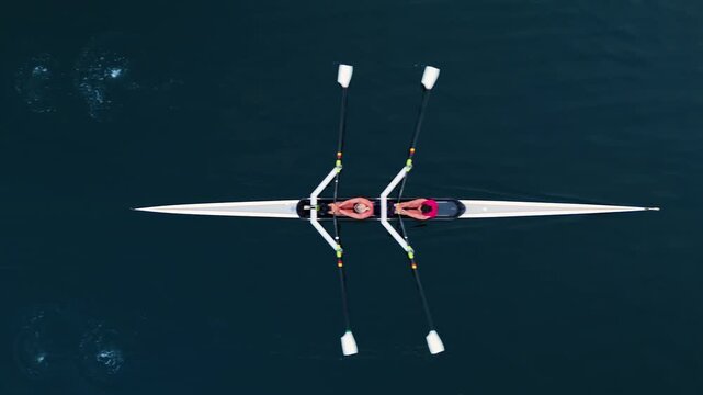 Watch young women athletes glide through the serene waters of Halifax Ocean Bay, showcasing their skills in a two-seater rowing boat. Experience the beauty of teamwork and dedication