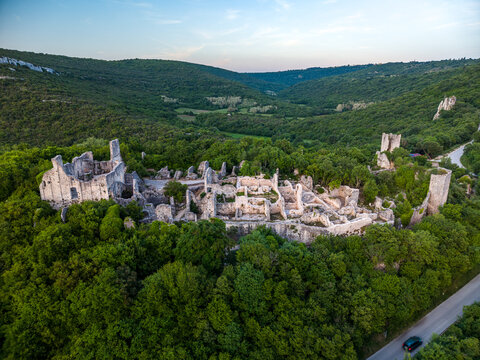 Aerial view of the ancient Dvigrad ruins surrounded by lush green forests and rolling hills in Kanfanar, Istria County, Croatia.
