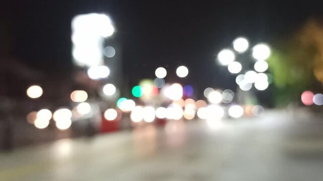 Artistic blur and refocused view of a crowded downtown street, capturing urban movement, city lights, and dynamic metropolitan atmosphere.
