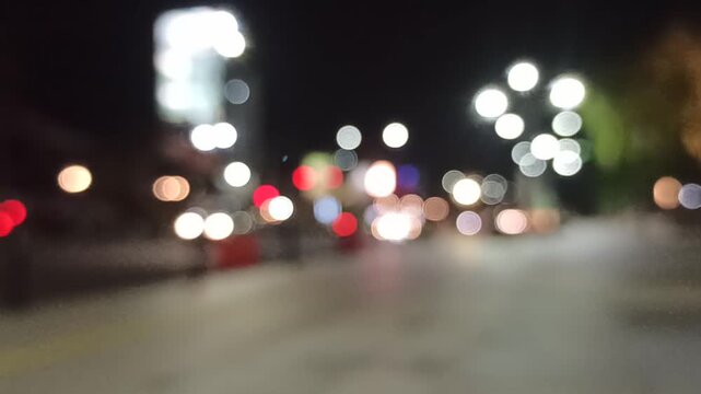 Artistic blur and refocused view of a crowded downtown street, capturing urban movement, city lights, and dynamic metropolitan atmosphere.