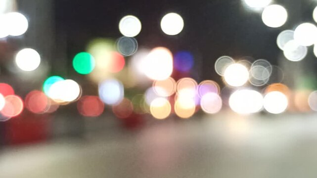 Artistic blur and refocused view of a crowded downtown street, capturing urban movement, city lights, and dynamic metropolitan atmosphere.