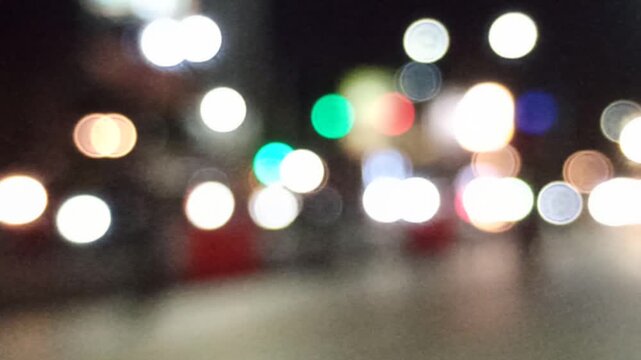 Artistic blur and refocused view of a crowded downtown street, capturing urban movement, city lights, and dynamic metropolitan atmosphere.