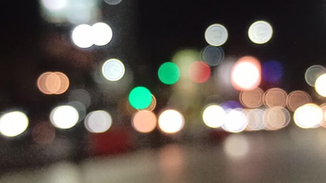 Artistic blur and refocused view of a crowded downtown street, capturing urban movement, city lights, and dynamic metropolitan atmosphere.