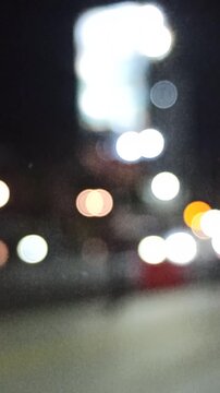 Artistic blur and refocused view of a crowded downtown street, capturing urban movement, city lights, and dynamic metropolitan atmosphere.