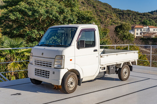 Tokyo, Japan-February 15, 2025: White kei car flatbed truck parked in Japan.