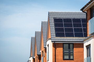 Photovoltaic solar panels on the roof of new built house in england uk. The concept of a sustainable environment, construction. © Jevanto Protography